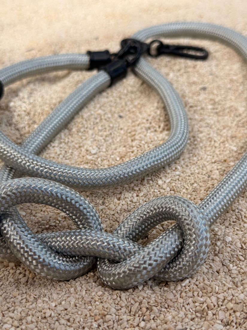 Silver lanyard tied in a knot, close-up of the woven nylon