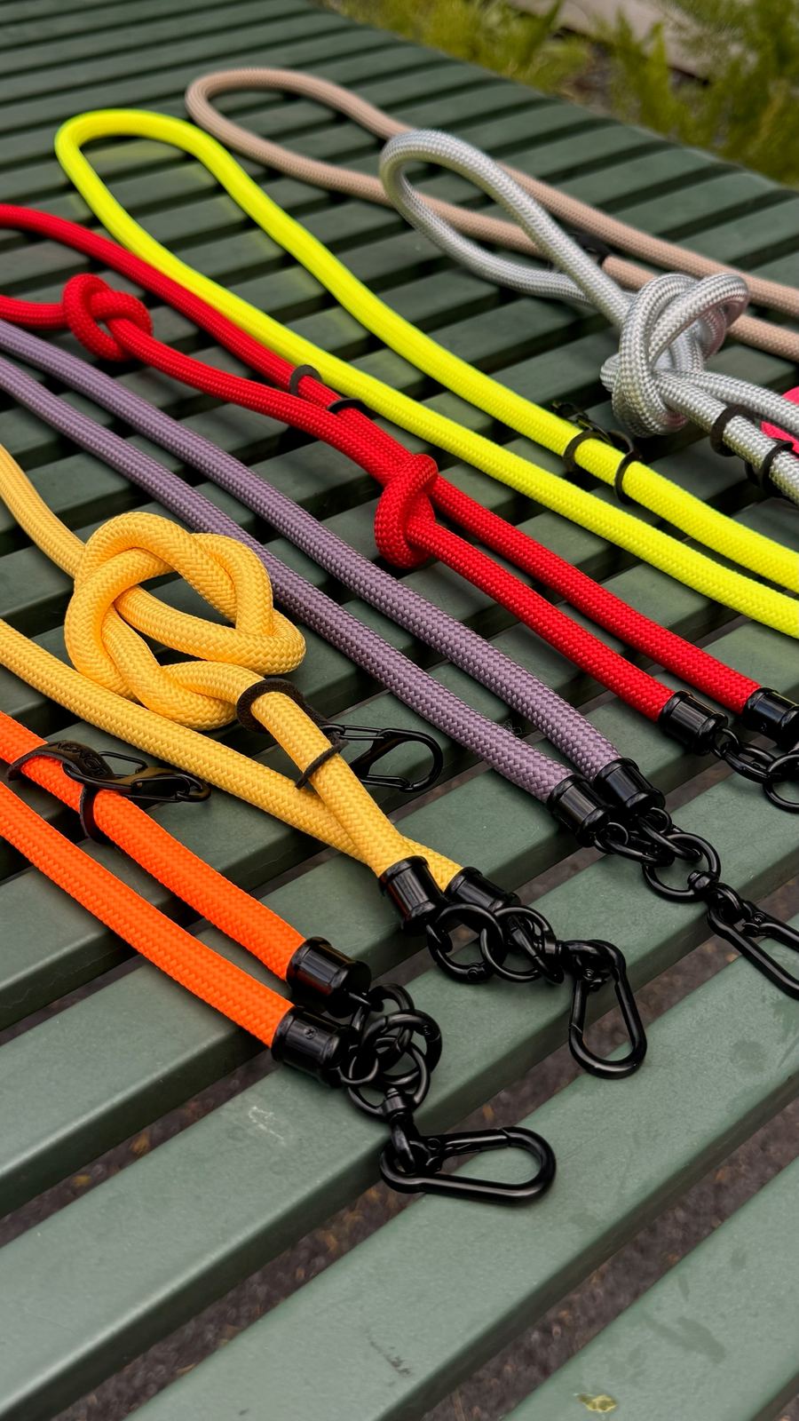 Bongini lanyards in many colors laid out on a bench