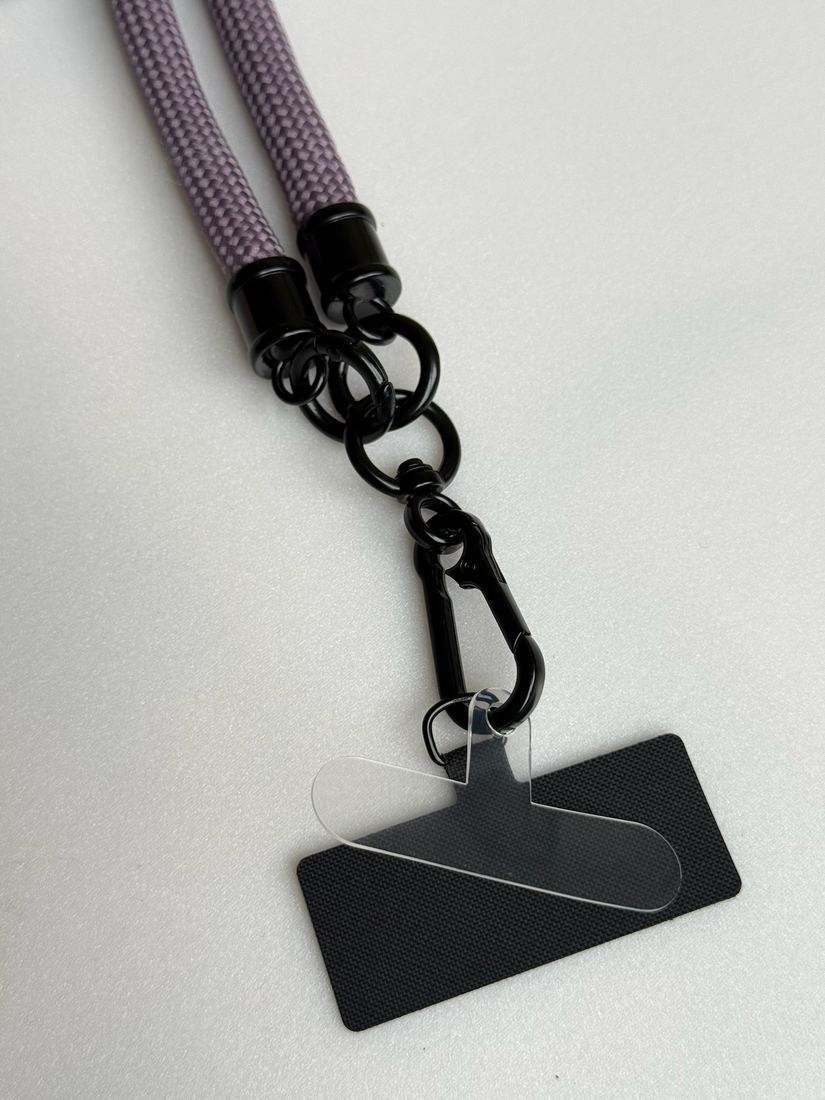 Metal carabiners and rings on an eggplant lanyard